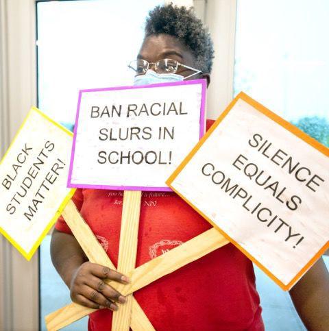 mahomet school seymour attention racism anti gets resolution gazette board entryway prairie middletown lashanda glover holds elementary signs before her