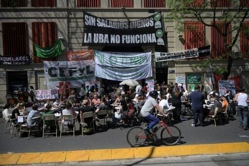 Students take a class in the street outside the faculty of philosophy and letters of the University of Buenos Aires (UBA) in Buenos Aires on October 16, 2024. Students from Argentina's public universities are protesting President Javier Milei's funding ...