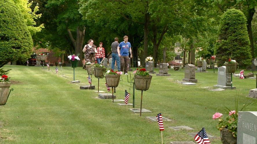 Volunteers place thousands of flags at gravestones of veterans in La Crosse Co. ahead of