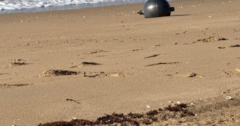 Mystery spheres on beach are likely space debris that fell back to ...