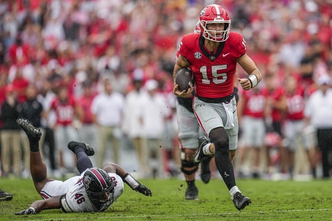 Beck throws and runs for TDs to launch new era as No. 1 Georgia