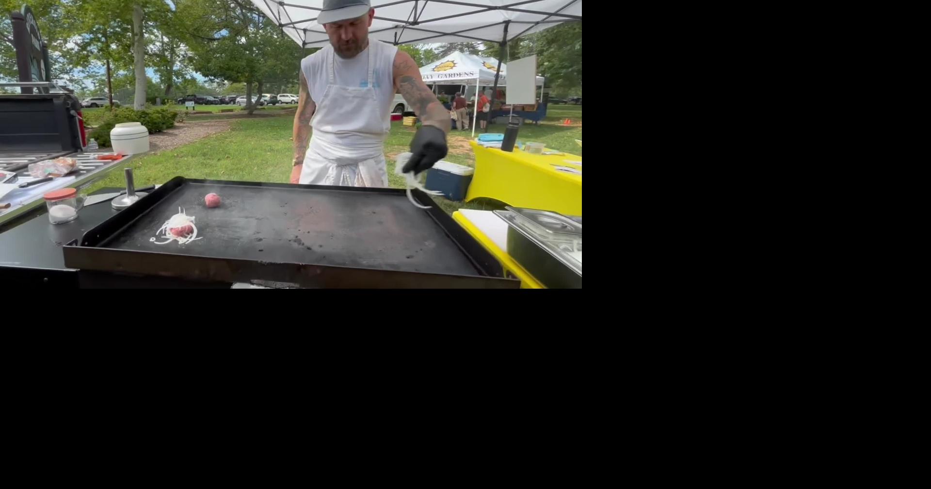 Jared Stuart prepares a burger at the Rivermont Farmers Market