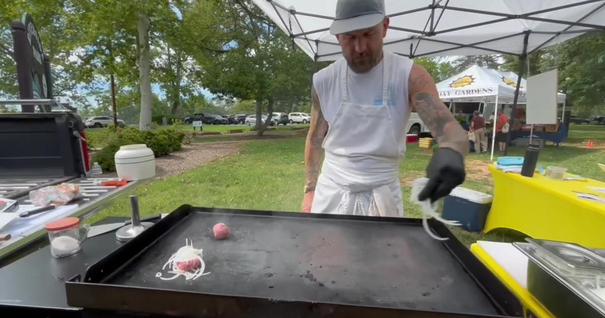 Jared Stuart prepares a burger at the Rivermont Farmers Market