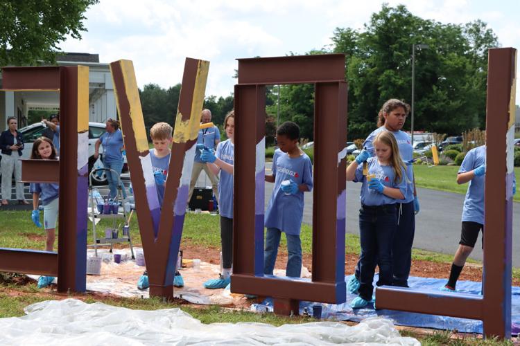 LOVE SIGN TES students painting letters8.JPG