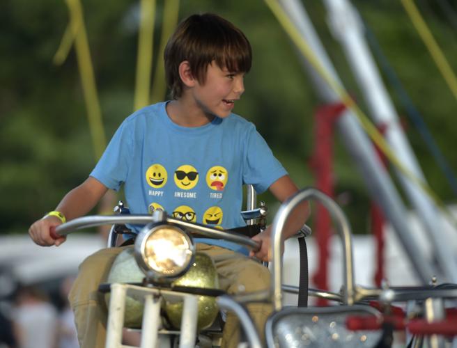 Taylor Kane, 7, of Amherst rides a motorcycle ride at the Amherst County Fair