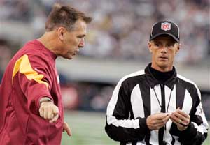 Former Washington Redskins head coach Jim Zorn, left, is all