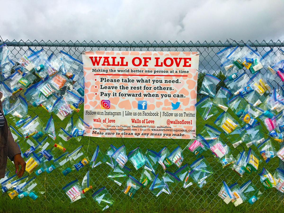 A place of giving Walls of Love volunteers decorate fence with necessities for Fairbanks