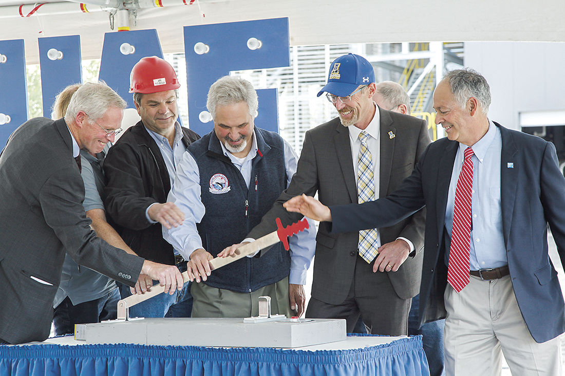 Instead of cutting a red ribbon or scooping dirt with a golden shovel, dignitaries flipped a ceremonial switch Wednesday afternoon to usher in nearly-complete combined heat and power plant at the University of Alaska Fairbanks. UAF followed the brief ceremony with tours of the facility. From left to right: UA President Jim Johnson, Usibelli Coal Mine President Joe Usibeli Jr., Alaska State Senator Pete Kelly, UAF Chancellor Daniel White and UAF senior project manager Mike Ruckhaus. Aug 30, 2018.