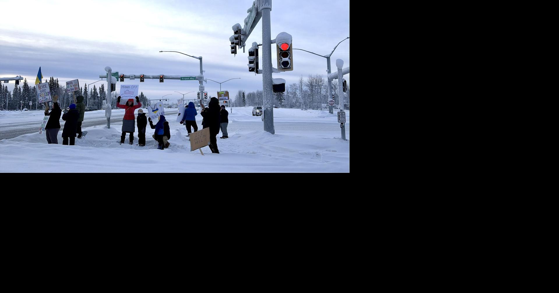 Demonstrators stand outside Fort Wainwright to protest U.S. action in Venezuela