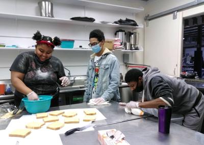 Ke'Niyah Smith, Earl Veney and Tyquon Clayton have fun preparing French toast.