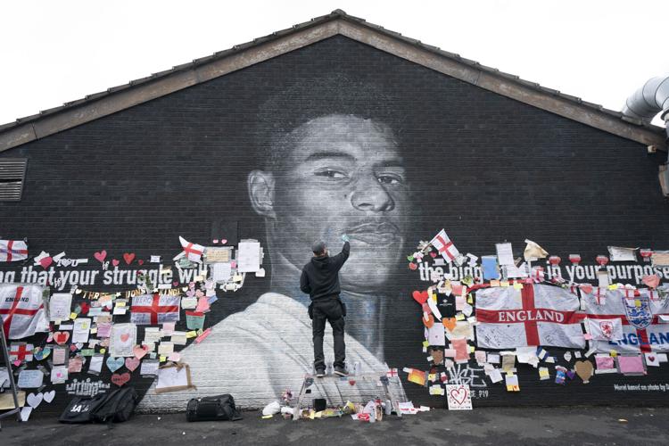 Defaced UK soccer star mural transformed into symbol of anti