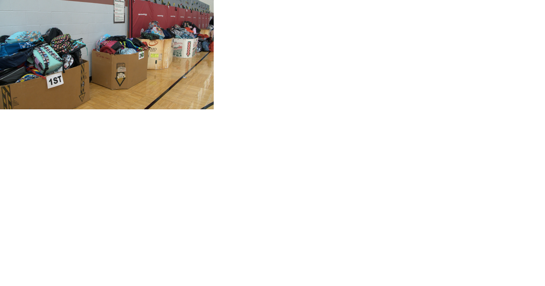 Volunteers prepare to hand out school supplies Thursday - Vimarsana News
