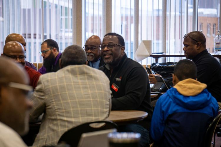 PHOTOS Over 100 black male students, staff and faculty gather for