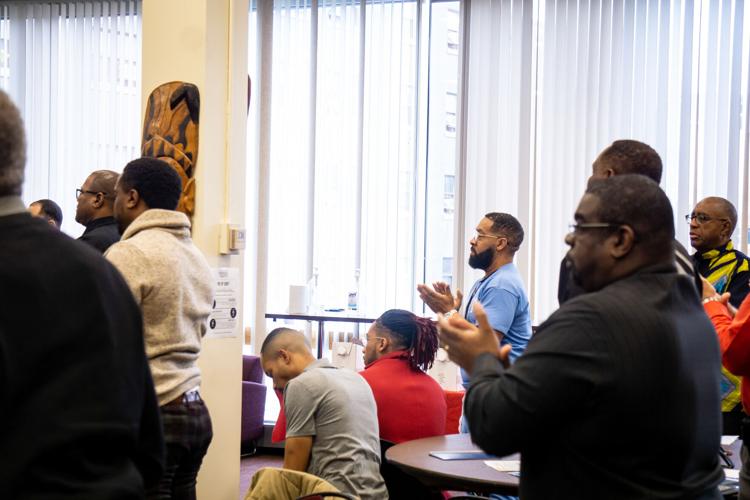 PHOTOS Over 100 black male students, staff and faculty gather for