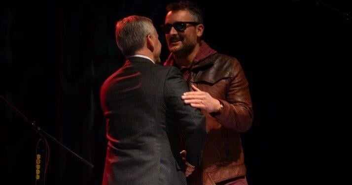 Gov. Stein presents Eric Church with state flag