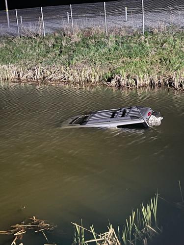 Woman rescued after driving vehicle into pond