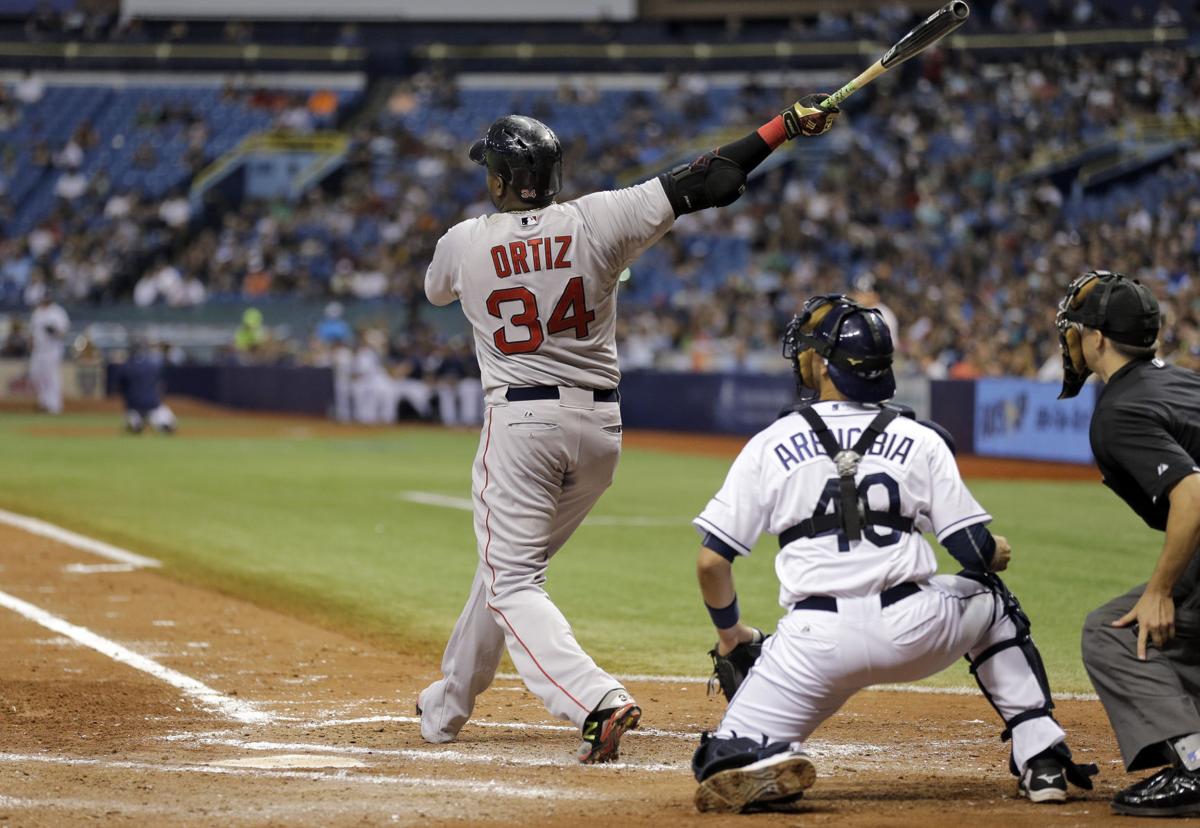 Boston Red Sox's Manny Ramirez kisses a bat as he returns to the plate from  the dug out after breaking a bat in the first inning of a baseball game  against the