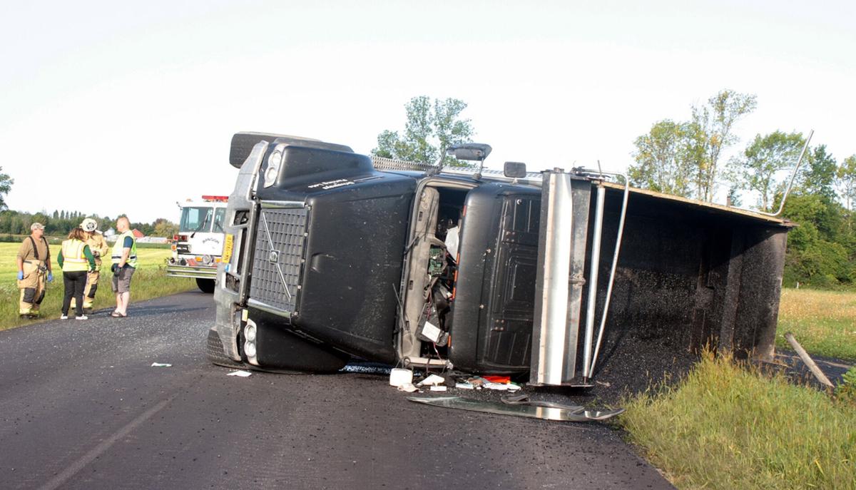 Driver hauling asphalt injured when dump truck overturns ...