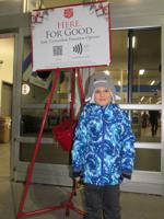 Trinity Catholic School student mans red kettles for Salvation Army