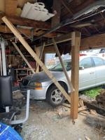 Car crashes into Watertown garage, driver flees scene