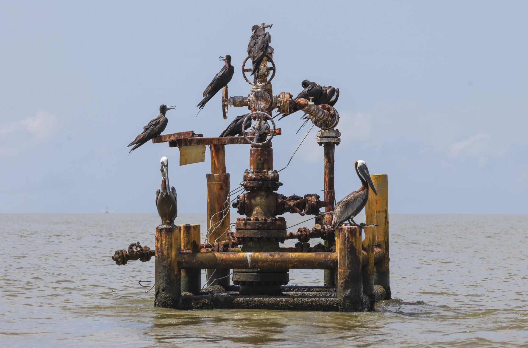 Sunken oil well infrastructure along Louisiana's eroding coastline