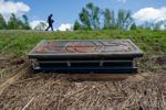 Three weeks after Ida toppled tombs in Ironton's cemetery, caskets remain scattered across the community
