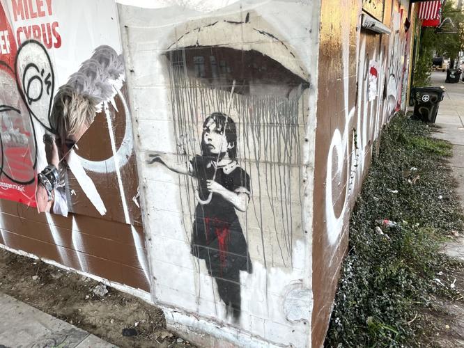 A Banksy graffiti painting, vandalized on Christmas, was restored by fast-acting artists 3.jpeg