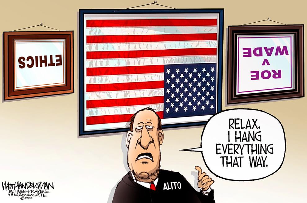 Samuel Alito standing before a wall where the American flag, Roe v. Wade, and Ethics are all upside down.  Alito SAYS, 