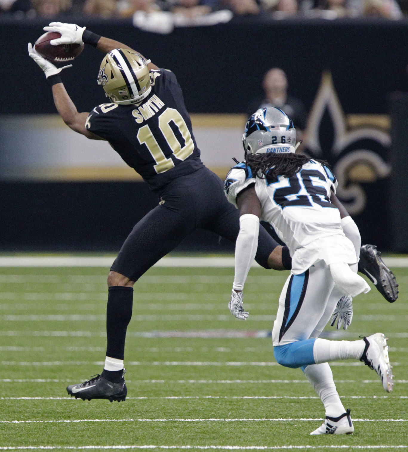 Carolina Panthers wide receiver D.J. Moore (12) takes a Kyle Allen pass 20  yards foe a touchdown against the New Orleans Saints at the Mercedes-Benz  Superdome in New Orleans December 30, 2018.