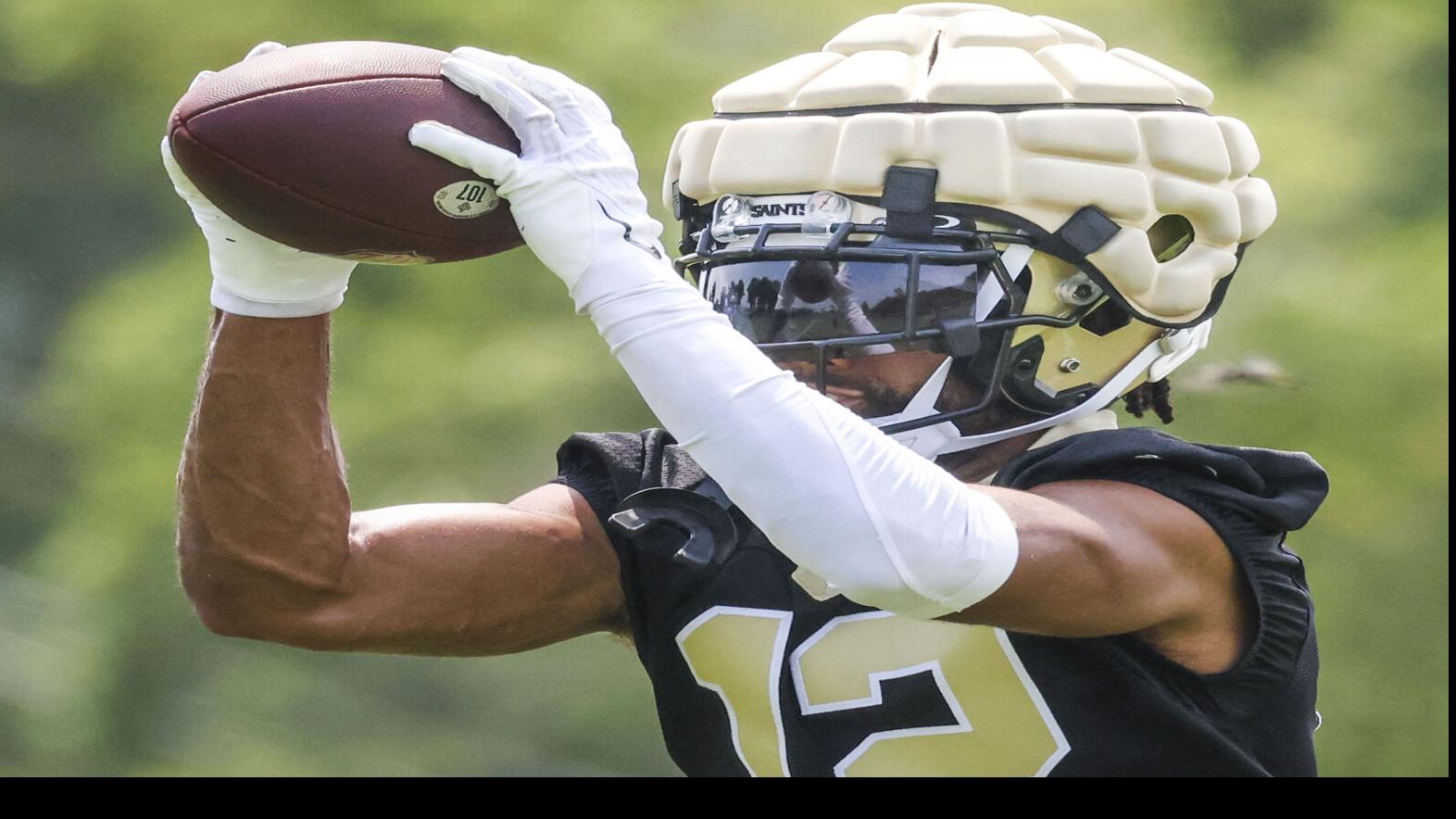 New Orleans Saints first round draft pick, wide receiver Chris Olave (12),  high fives quarterback Jameis