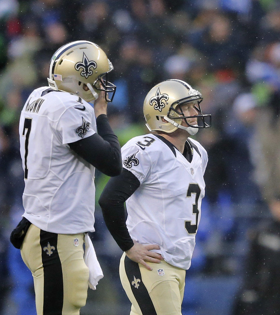 A stunned New Orleans Saints' Roman Harper walks off the field as the  Seattle Seahawks' celebrate their 41-36 win over the Super Bowl Defending  Champions in the NFC's wild-card playoff game on