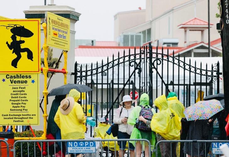 Fans wait in the rain outside the first base gate before the