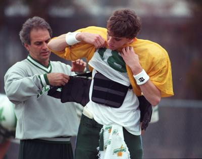 Newman High School junior quarterback Eli Manning speaks with coach Frank  Gendusa prior to a game against Warren Easton in New Orleans, Sept. 12,  1997. Eli is the son of former Saints