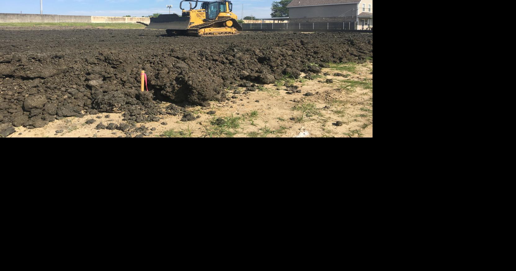 Contractor placing twofootdeep soil cap on Bellaire Drive lot