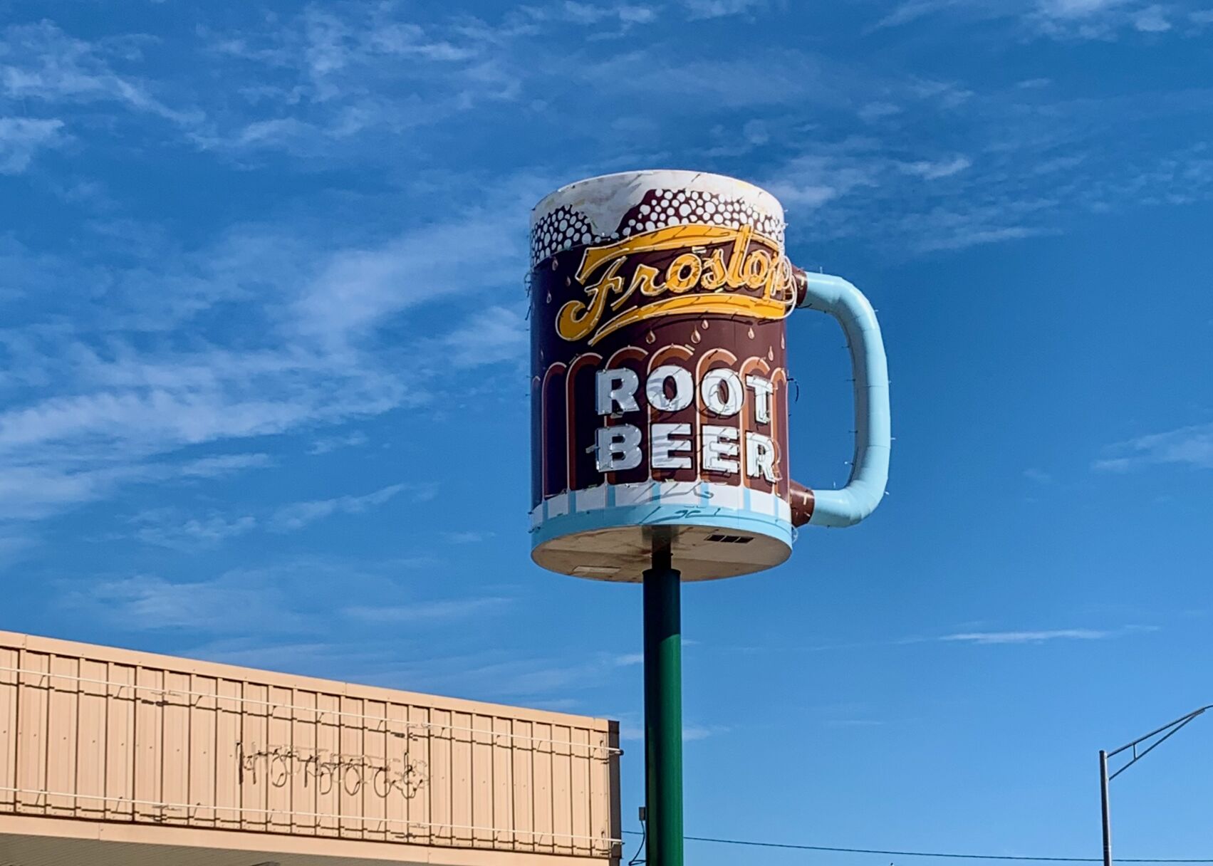 With neon and nostalgia, a giant root beer mug returns to its