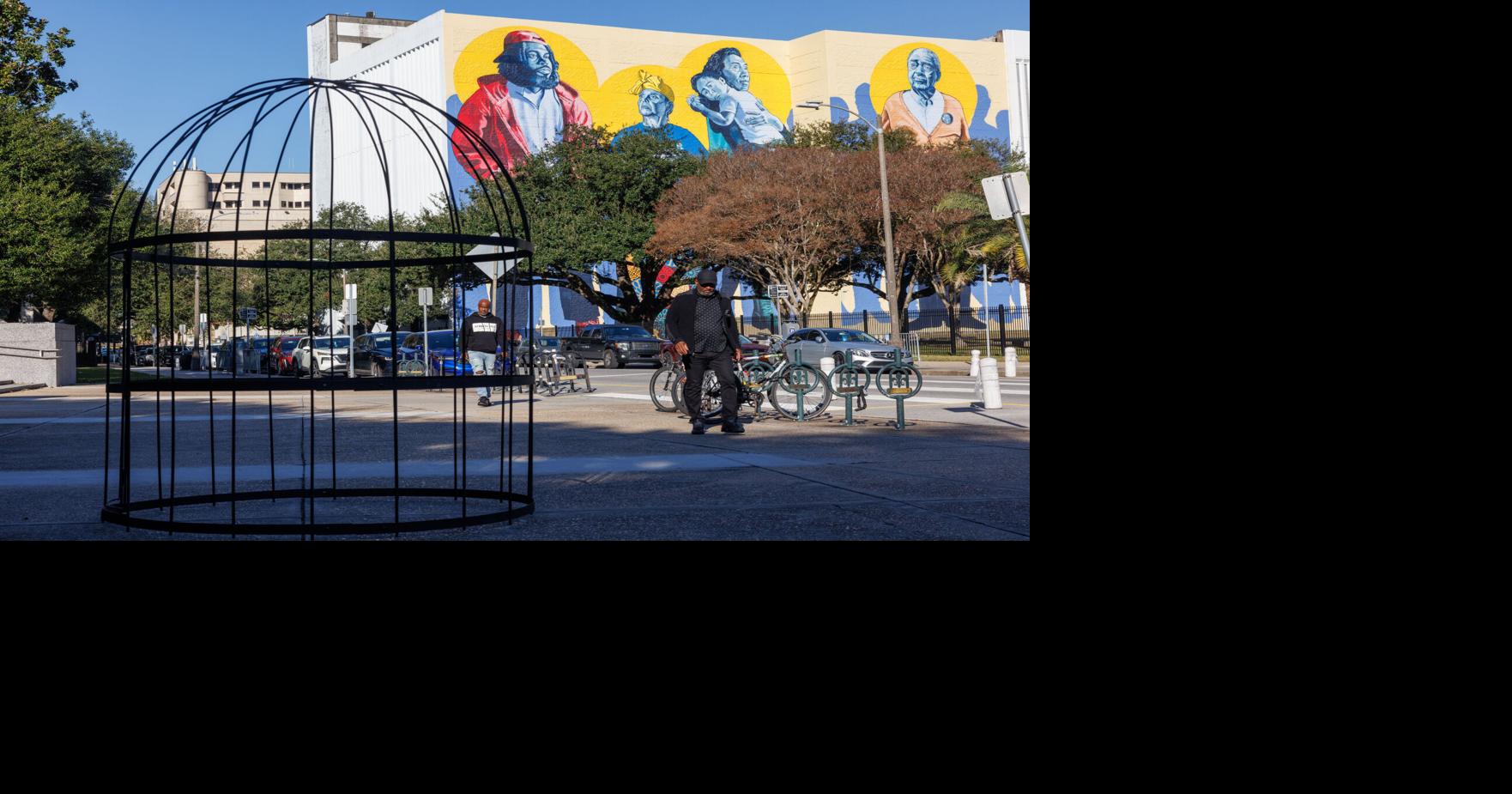 A giant birdcage appears outside New Orleans City Hall, calling attention to ICE raids