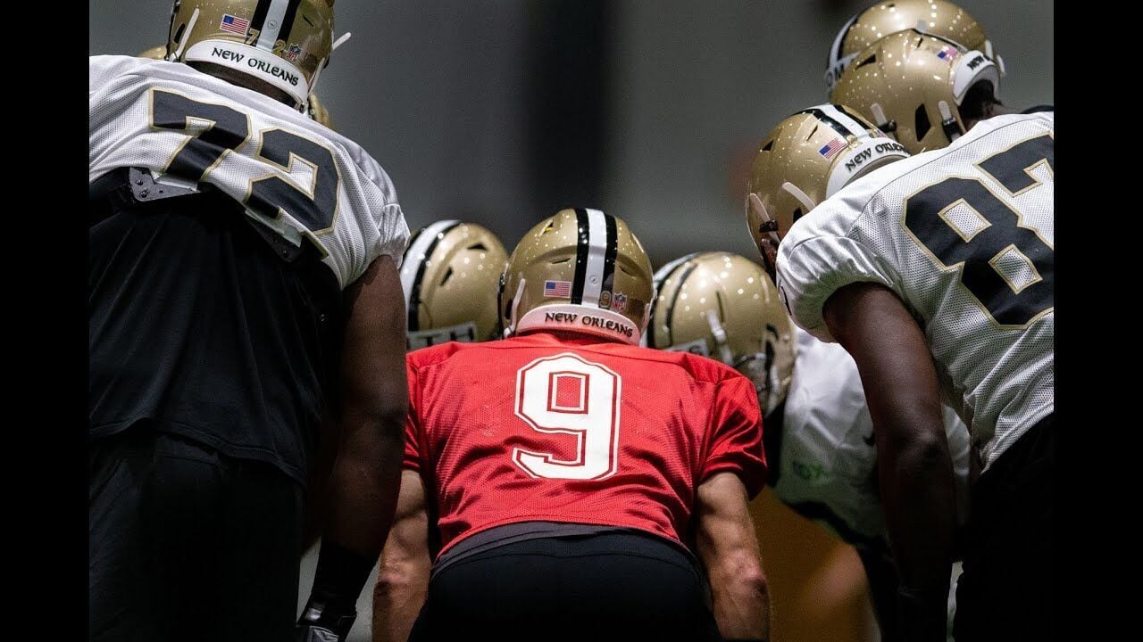 New Orleans Saints and former San Diego quarterback Drew Brees and General  Manager Mickey Loomis, right, hold a Saints jersey presented to Brees  during a news conference at the New Orleans Saints