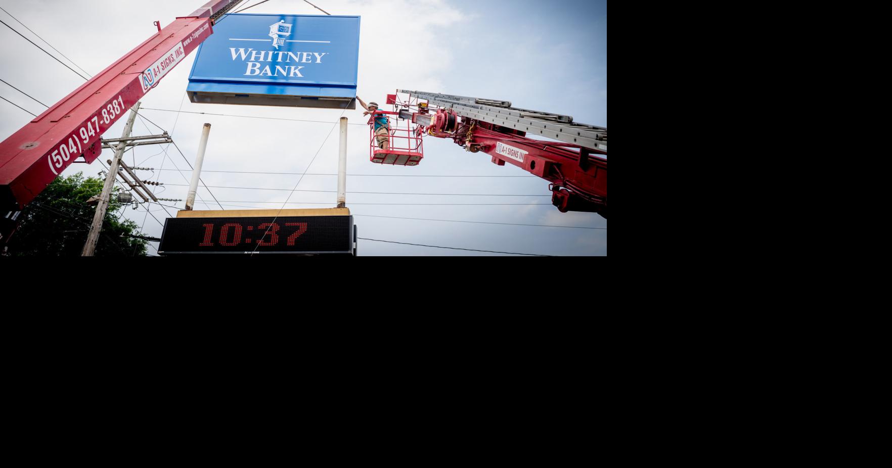 Whitney officials hang new sign on former First NBC branch in Metairie ...