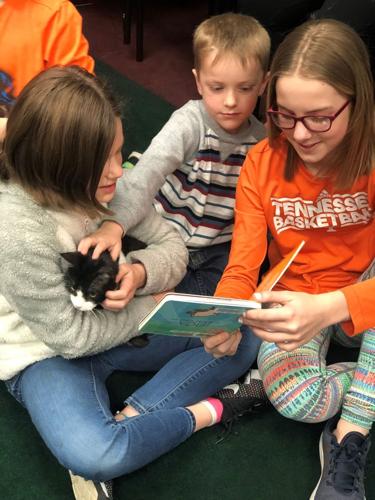 Kids reading at Catoosa Library with cat