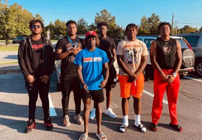 Rome High School football players rush to assist motorist trapped in car