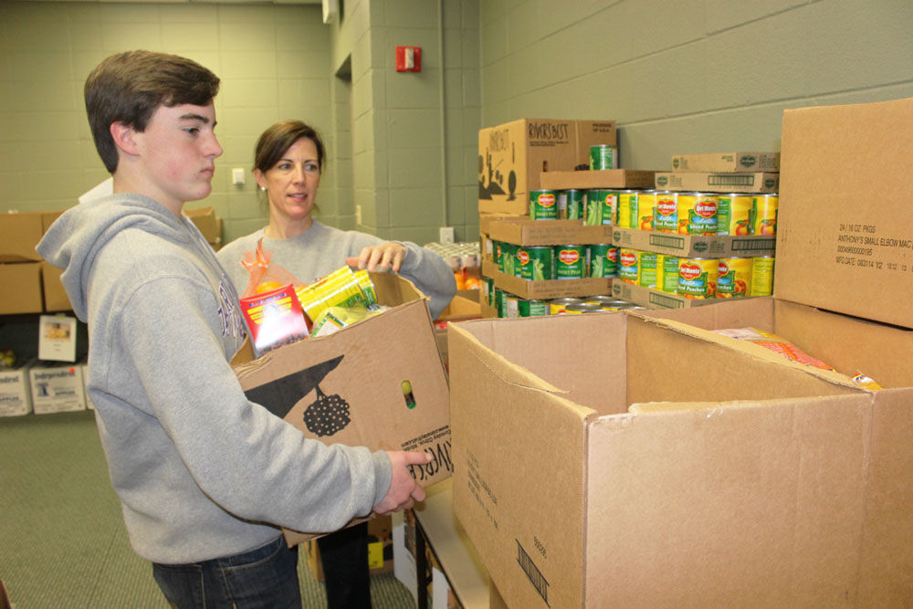 First Presbyterian Church members pack Christmas food boxes for needy