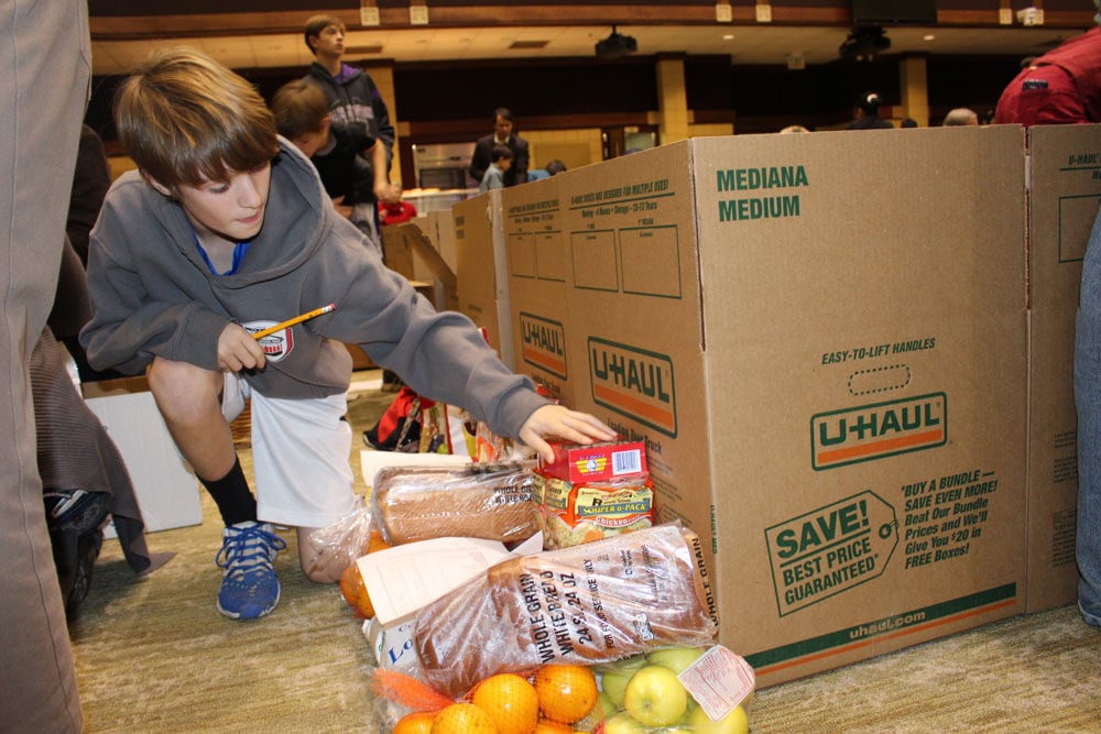 First Presbyterian Church members pack Christmas food boxes for needy