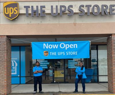 Owner Pascha Burge and her son Nicholas stand proudly outside The UPS Store #8071, now open at 2204 Shorter Avenue in Rome.