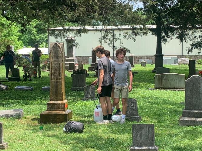 Gordon Lee 8th graders cleaning cemetery headstones