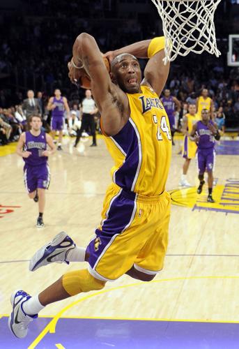 Los Angeles Lakers' Kobe Bryant, left, holding the Championship