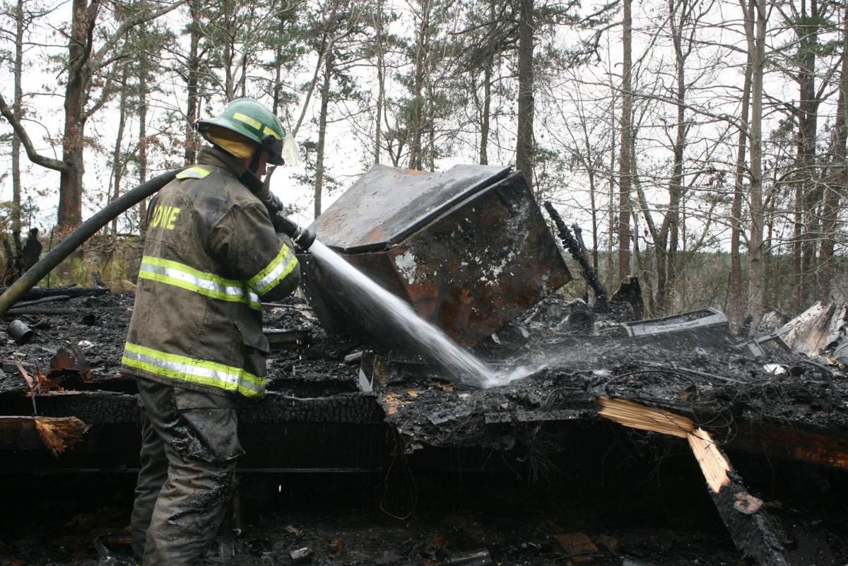 Fire under investigation as arson, vacant mobile home burns on a hill