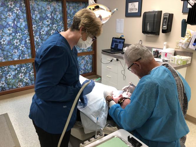 Dr. Alan Liesinger works on patient at his office
