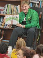 UO football lineman makes visit to Drain to read to elementary students