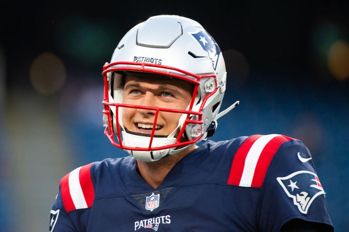 Mac Jones #10 of the New England Patriots smiles during warm ups prior to the start of the game against the Washington Football Team at Gillette Stadium on August 12, 2021 in Foxborough, Massachusetts.