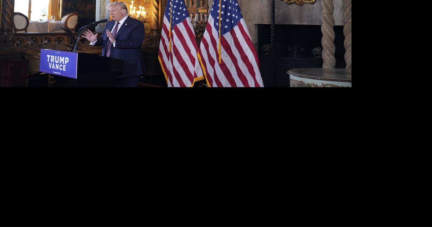 arafed image of a man standing at a podium with american flags